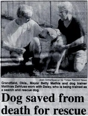 A newspaper clipping of two people and their dog.